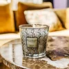 Mini bougie parfumée My First Baobab BRUSSELS allumée sur une table d'appoint